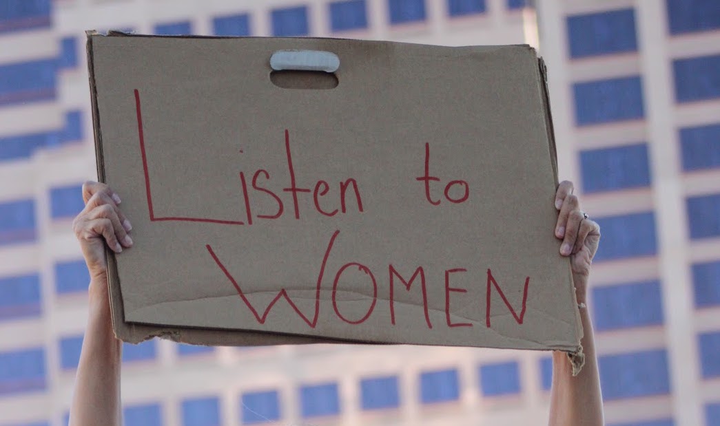 sign saying listen to women