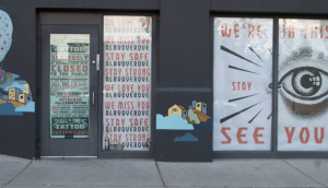 storefront signage says "we're all in this together"