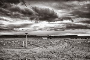 isolated house on large prairie with large cloud formations