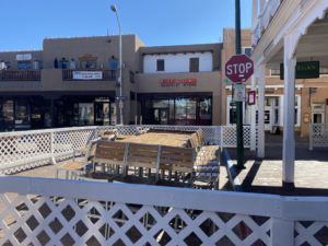 Tables and chairs locked up and await busier and warmer days for on-street dining at Thunderbird Bar & Grill