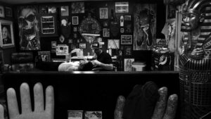 Rick Gandara tattoos his customer Jay Brock at the Poison Apple Tattoo shop, Albuquerque, New Mexico. Dec. 1, 2022