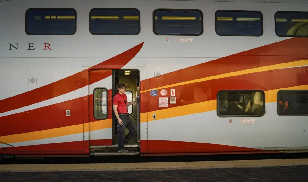 A New Mexico Rail Runner Express employee checks for any last-minute passengers boarding at the Santa Fe Depot on Monday, Oct. 19, 2026.