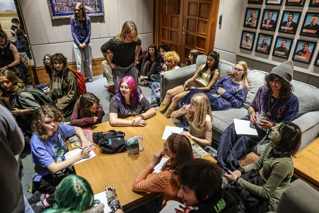 Protesters, mostly students from the New Mexico School for the Arts, write letters to the governor and her staff expressing their concerns about Project Jupiter, data centers and artificial intelligence outside the governor’s office on Tuesday, Oct. 27, 2026.